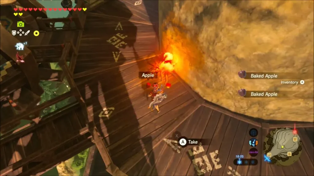 Link picking up baked apples next to the campfire