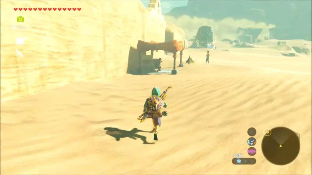 Link running across the sand toward Bozai's canopy at the edge of Gerudo Town Link running across the sand toward Bozai's canopy at the edge of Gerudo Town