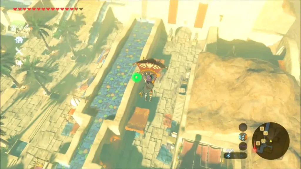 Link gliding above the water channel that runs through Gerudo Town Link gliding above the water channel that runs through Gerudo Town