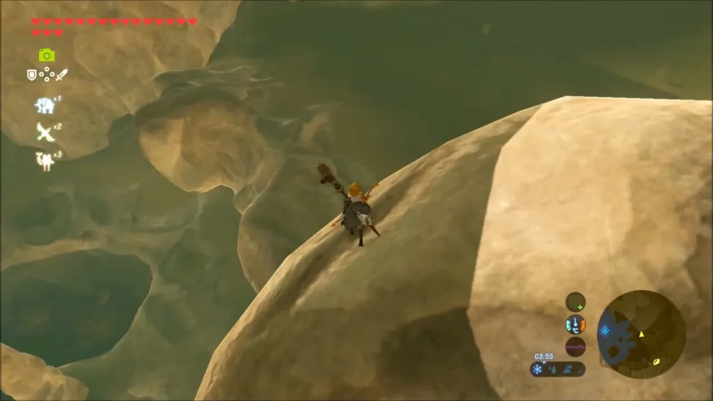 Link climbing a rounded pale limestone boulder over a rocky drop Link climbing a rounded pale limestone boulder over a rocky drop