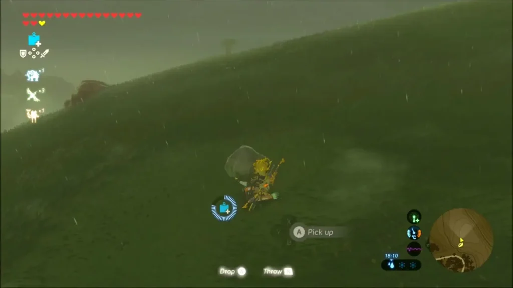 Link picking up a lone rock on a grassy rain-soaked hillside Link picking up a lone rock on a grassy rain-soaked hillside