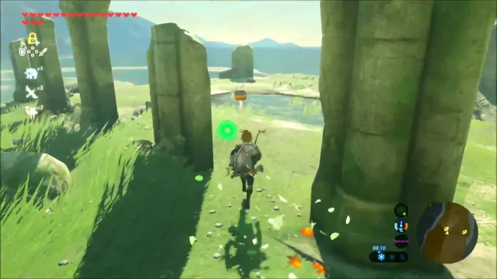 Link running between fallen stone pillars on the grassy slope above the beach Link running between fallen stone pillars on the grassy slope above the beach