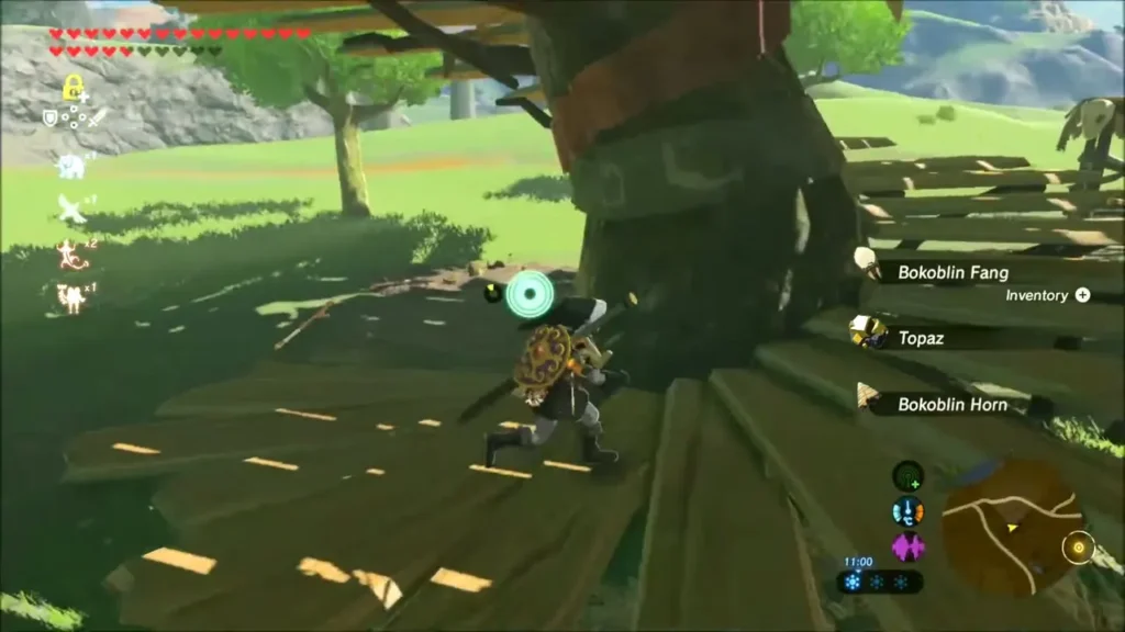 Link picking up Bokoblin loot and a Topaz on the camp platform Link picking up Bokoblin loot and a Topaz on the camp platform