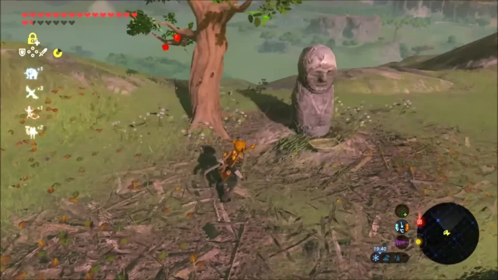 Stone Korok statue beside a tree with a twig nest at its feet Stone Korok statue beside a tree with a twig nest at its feet