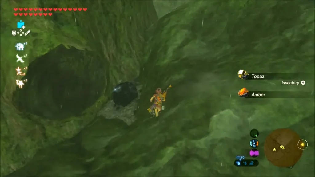 Link beside a cave opened by a bombed boulder, collecting Topaz and Amber Link beside a cave opened by a bombed boulder, collecting Topaz and Amber