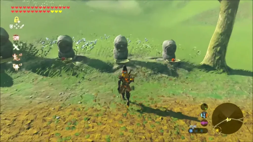 Row of small stone statues holding bowls with apples on the grass Row of small stone statues holding bowls with apples on the grass