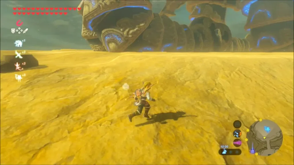 Link running over the sand with Vah Naboris looming in the distance Link running over the sand with Vah Naboris looming in the distance