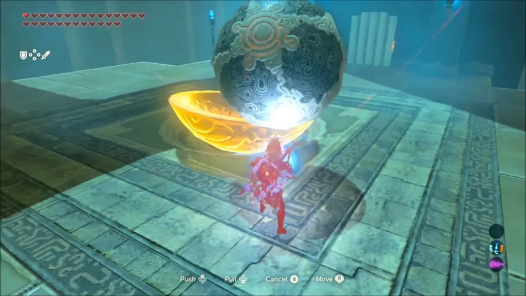 A large orb dropping into the metal bowl as Link steadies it A large orb dropping into the metal bowl as Link steadies it