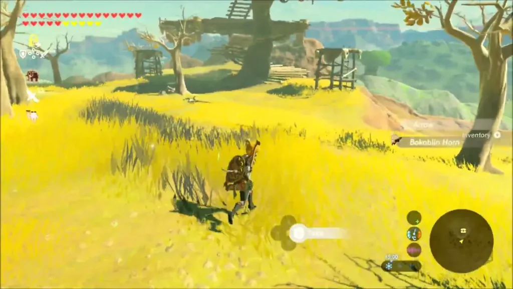 Link approaching the big wooden Bokoblin lookout in the grass Link approaching the big wooden Bokoblin lookout in the grass