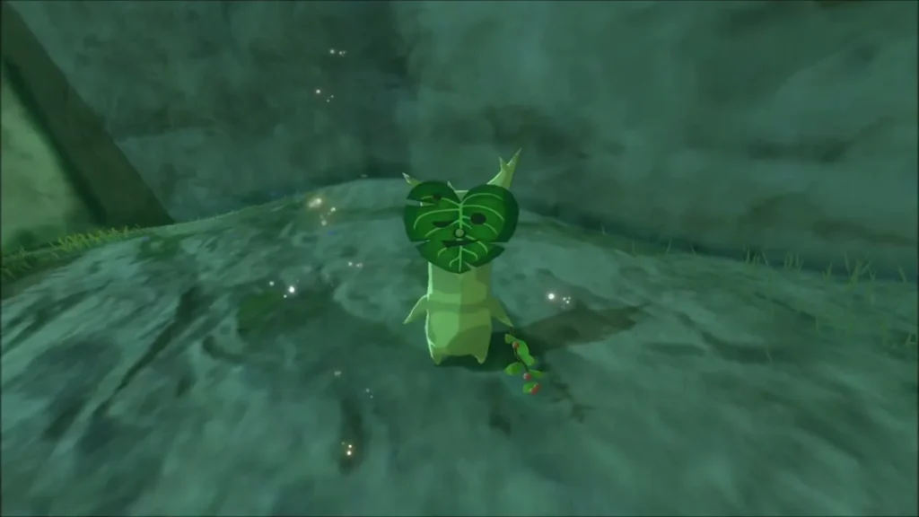 A Korok standing on the rocks below the cliff A Korok standing on the rocks below the cliff