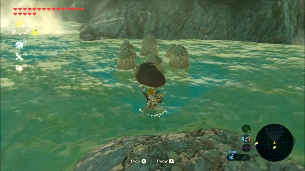 Link carrying a boulder overhead through the water toward a cluster of stone pillars Link carrying a boulder overhead through the water toward a cluster of stone pillars