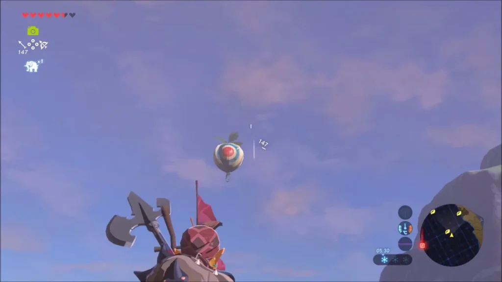 A balloon framed in the bow's aim against the sky
