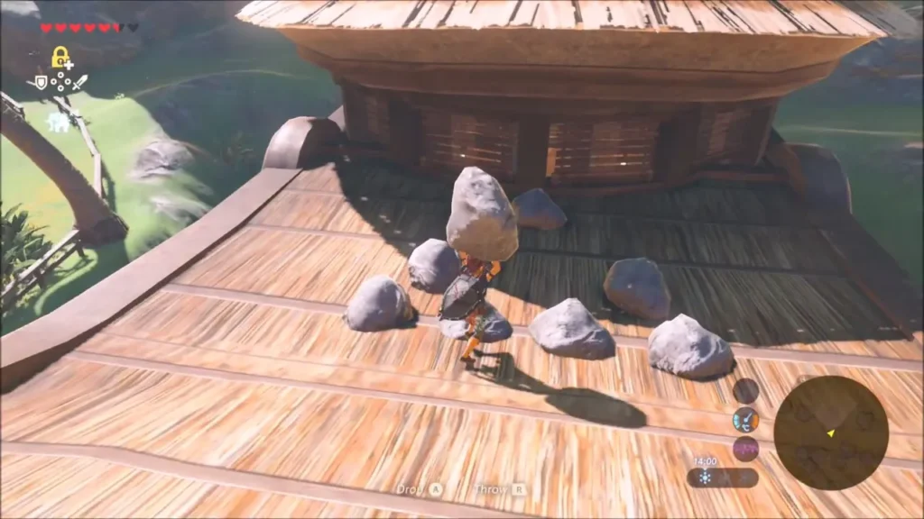 Link setting the boulder down among the small stones on the roof