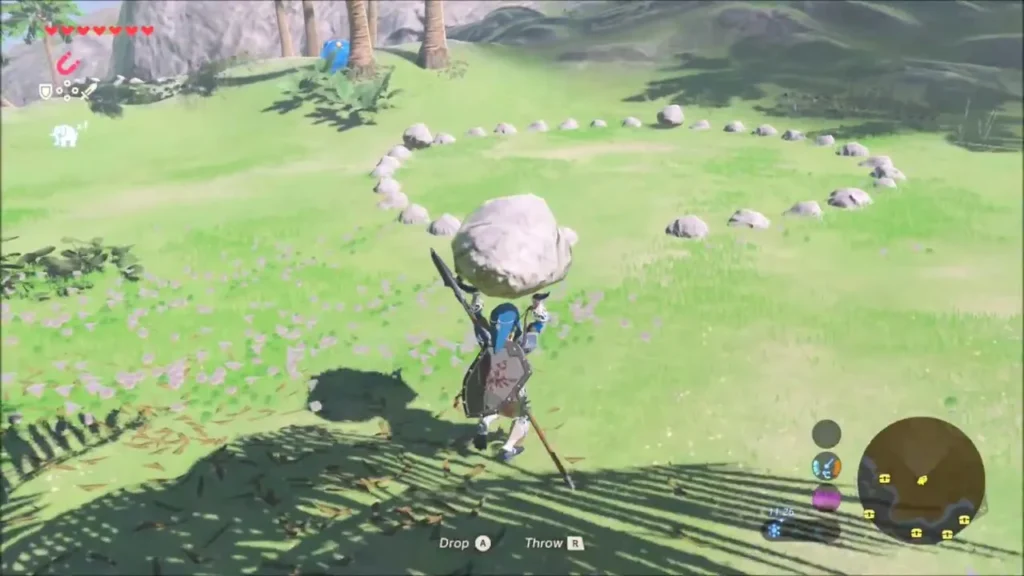 Link carrying a boulder toward the ring of stones