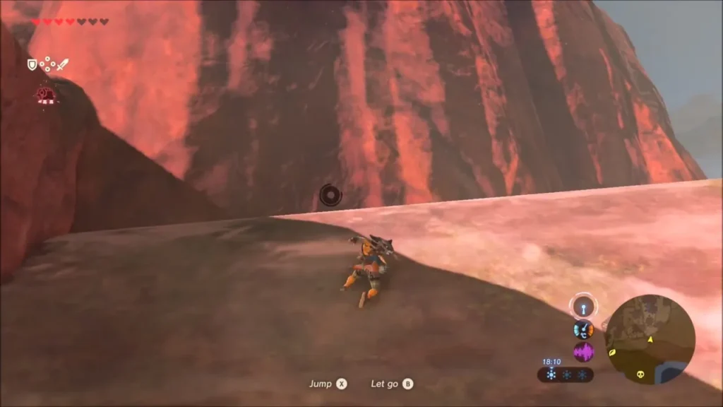 Link climbing the red cliff face