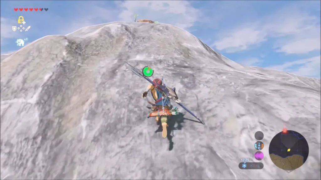 Link climbing the steep bare grey peak toward the summit