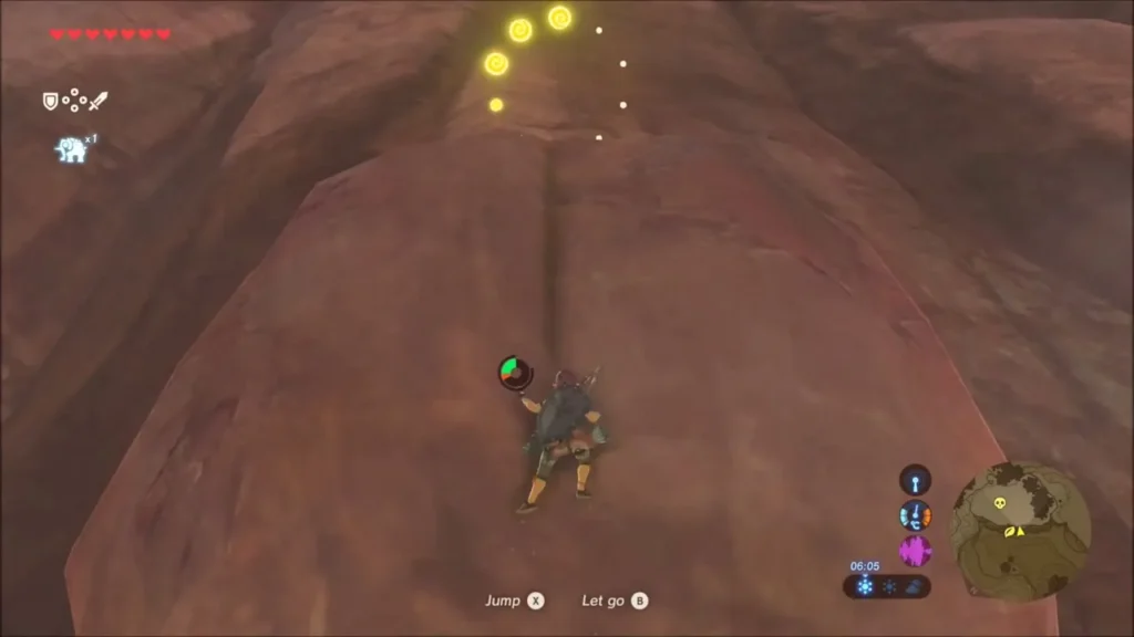Link climbing the red rock dome toward golden glimmers