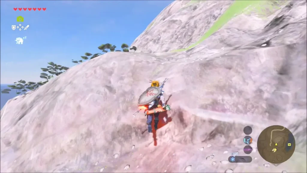 Link climbing the white rock slope above the pond