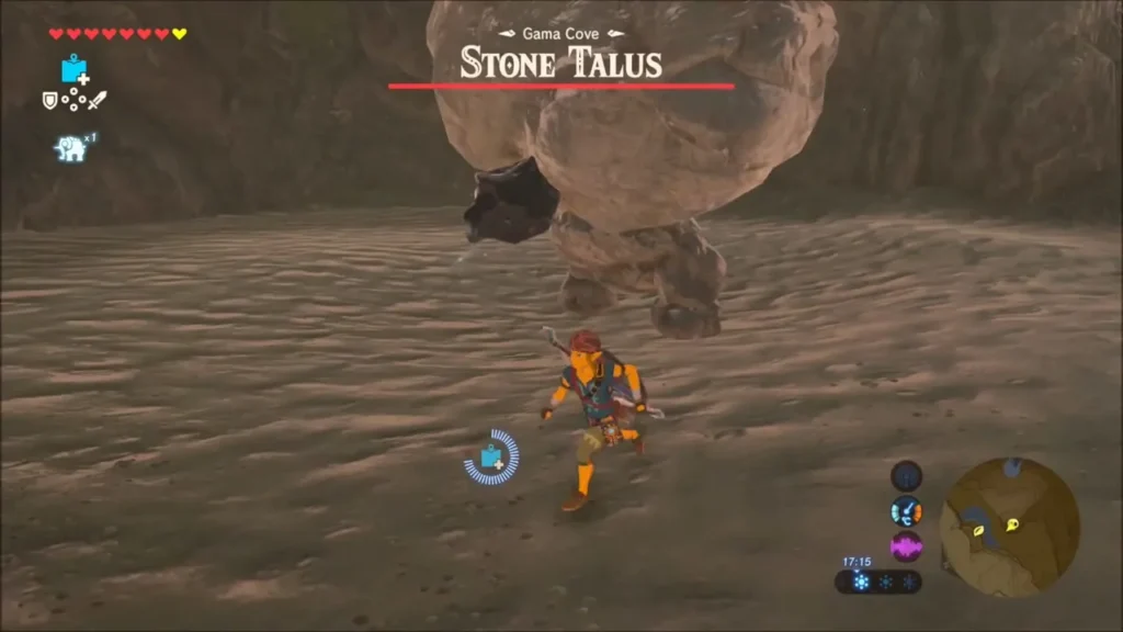 Stone Talus looming over Link on the sandy floor of Gama Cove
