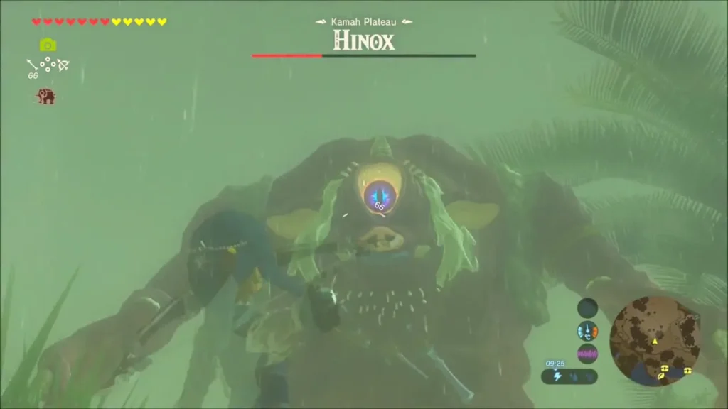The Hinox toppled with its eye exposed and Link climbing on it