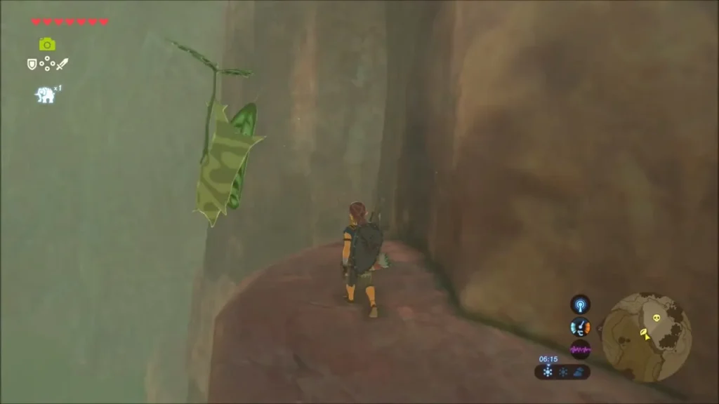Korok hanging from a leaf by the cliff, Link on the ledge