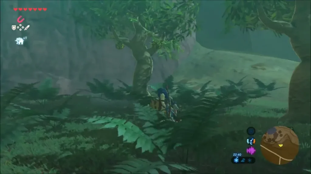 A Korok leaf mask in the grass among flowers at the edge of the forest