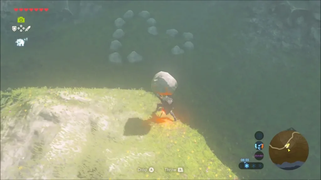 Link lifting the large loose rock at the edge of the stone ring