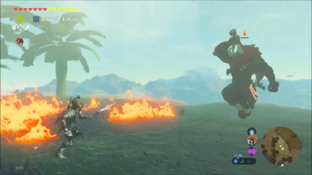 A Lynel leaping across burning grass toward Link