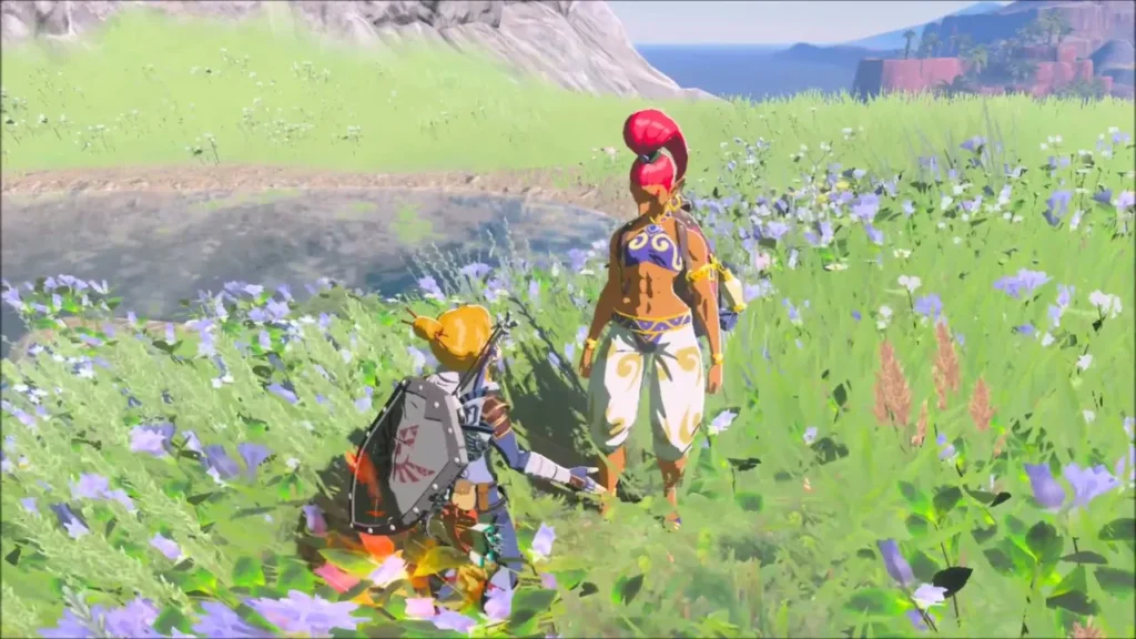 Link standing beside Perda among blue flowers at the pond