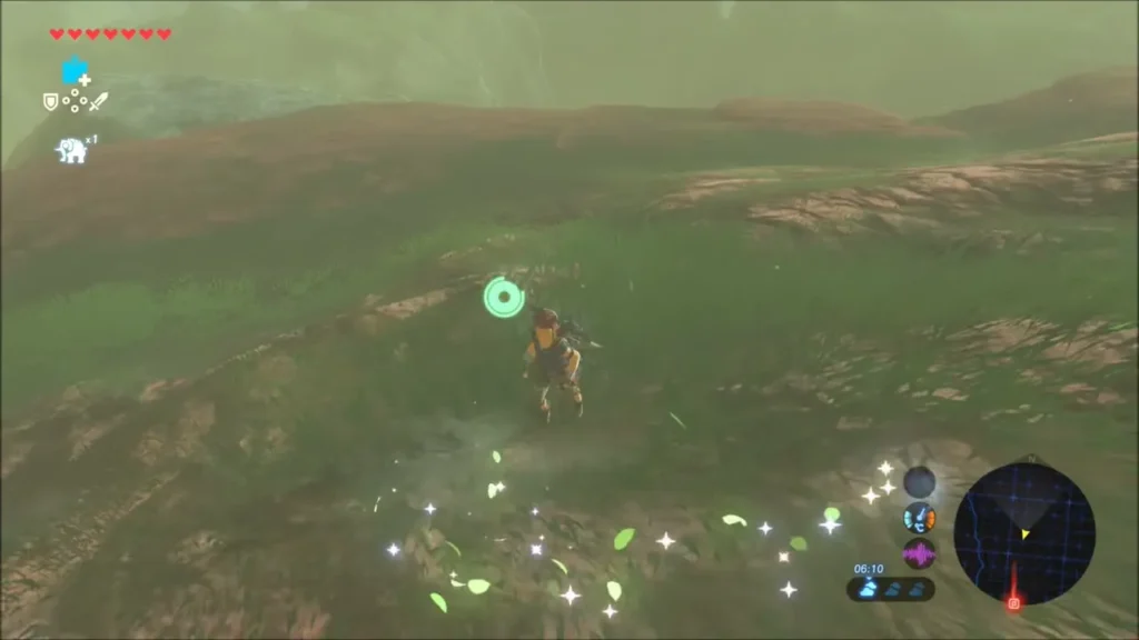 Glittering sparkles on a grassy slope as Link follows the trail