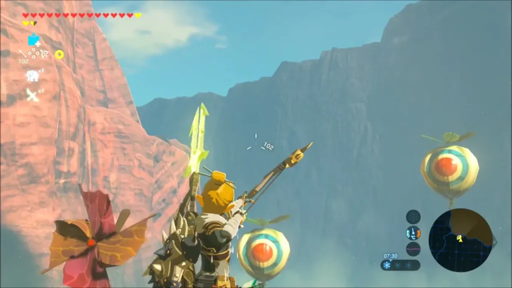Link aiming a bow at target balloons hanging beside a high red cliff Link aiming a bow at target balloons hanging beside a high red cliff