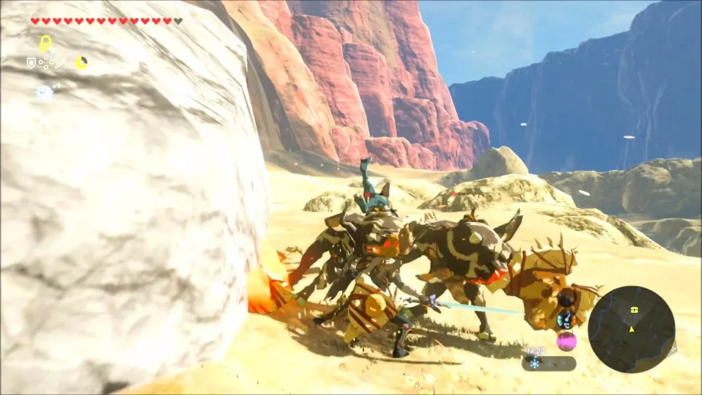 Link fighting a group of Bokoblins beside a white boulder at the camp Link fighting a group of Bokoblins beside a white boulder at the camp