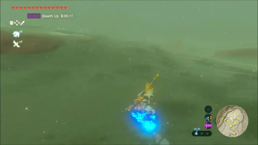 Link dragging a blue-lit chest free of the snow with Magnesis Link dragging a blue-lit chest free of the snow with Magnesis