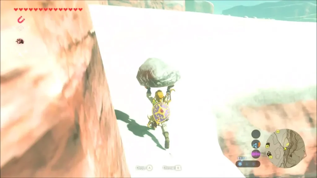 Link carrying a boulder along a snowy cliff ledge Link carrying a boulder along a snowy cliff ledge
