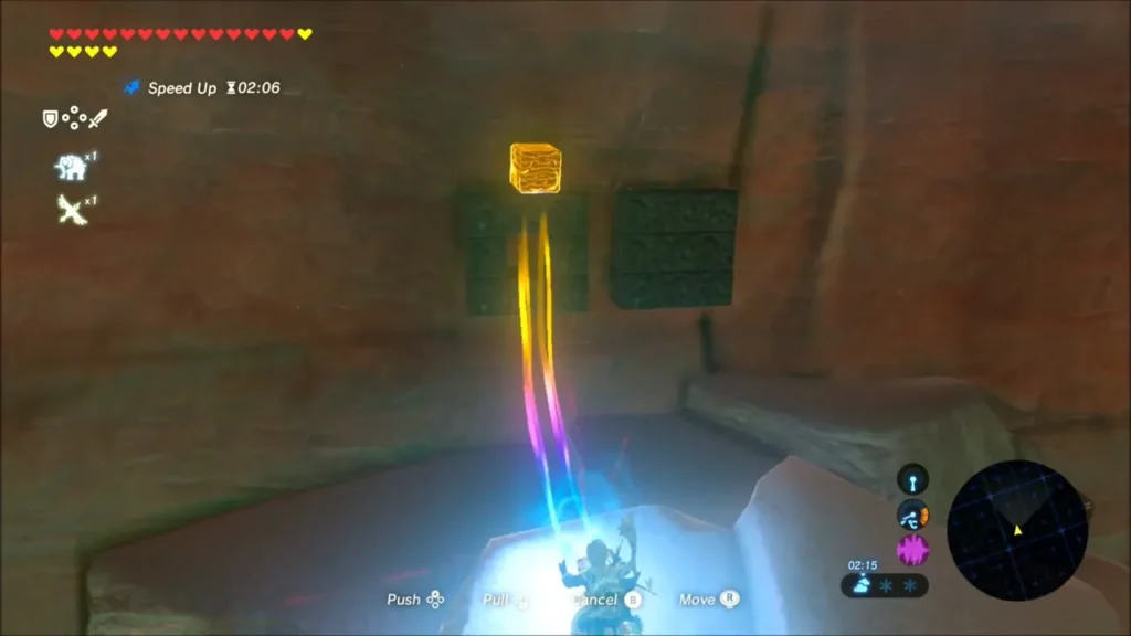 Link using Magnesis to pull a metal chest out of the red rock face Link using Magnesis to pull a metal chest out of the red rock face