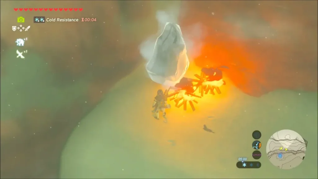 A wood campfire burning next to the ice block on the ledge A wood campfire burning next to the ice block on the ledge