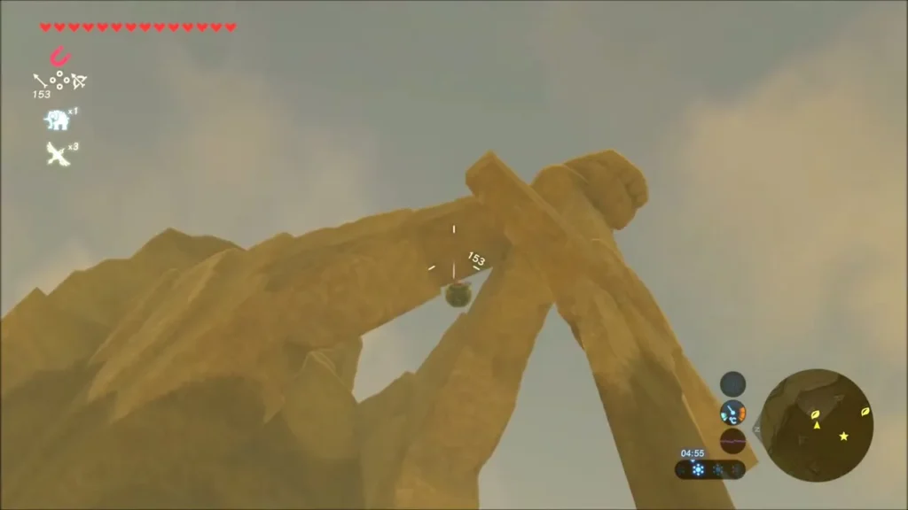 Looking up at a round object wedged between two leaning rock slabs, aimed at with a bow Looking up at a round object wedged between two leaning rock slabs, aimed at with a bow