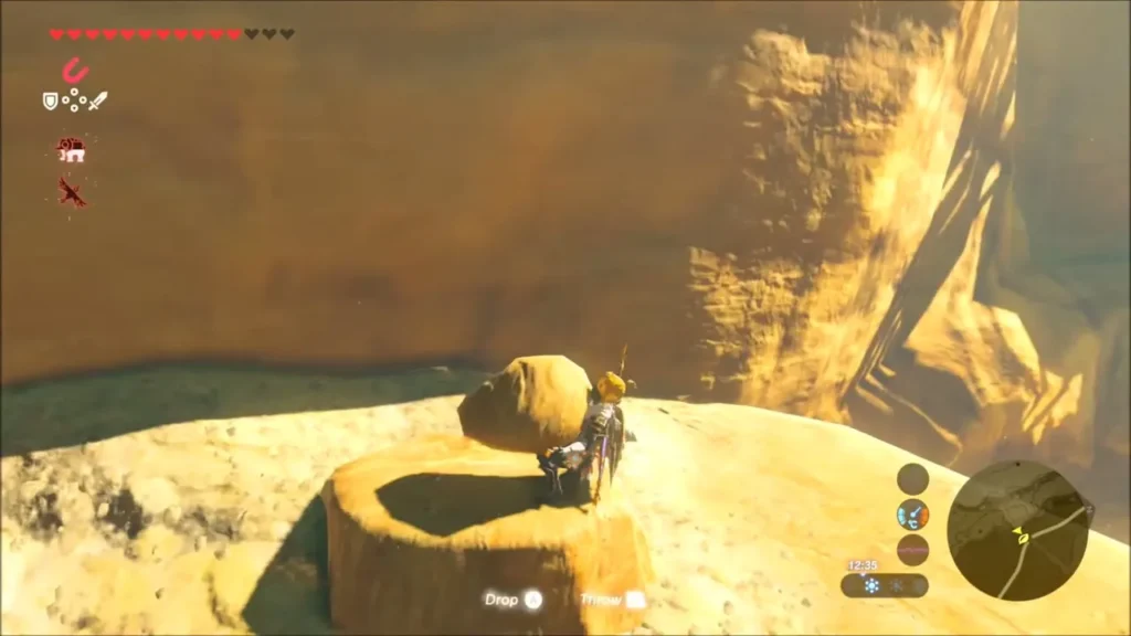 Link setting the boulder down on a stone pedestal Link setting the boulder down on a stone pedestal