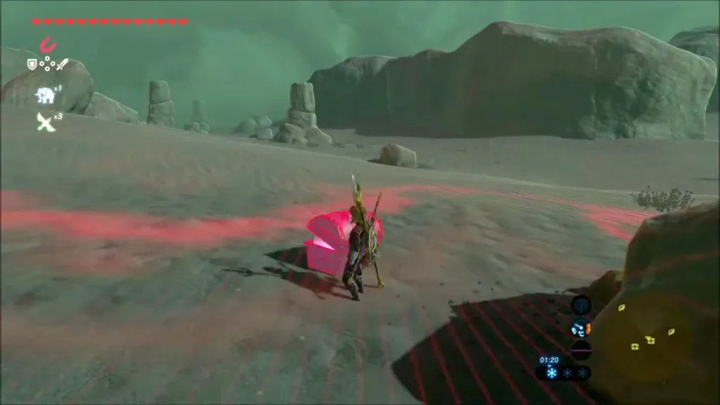 A buried chest glowing red beside Link among desert rocks A buried chest glowing red beside Link among desert rocks