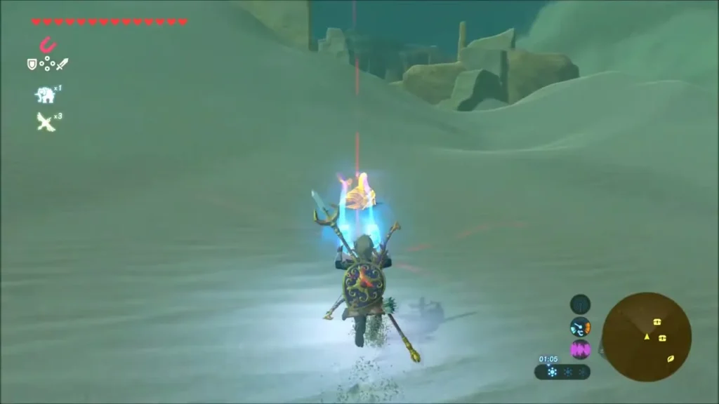A chest rises from the sand as Link lifts it with Magnesis A chest rises from the sand as Link lifts it with Magnesis