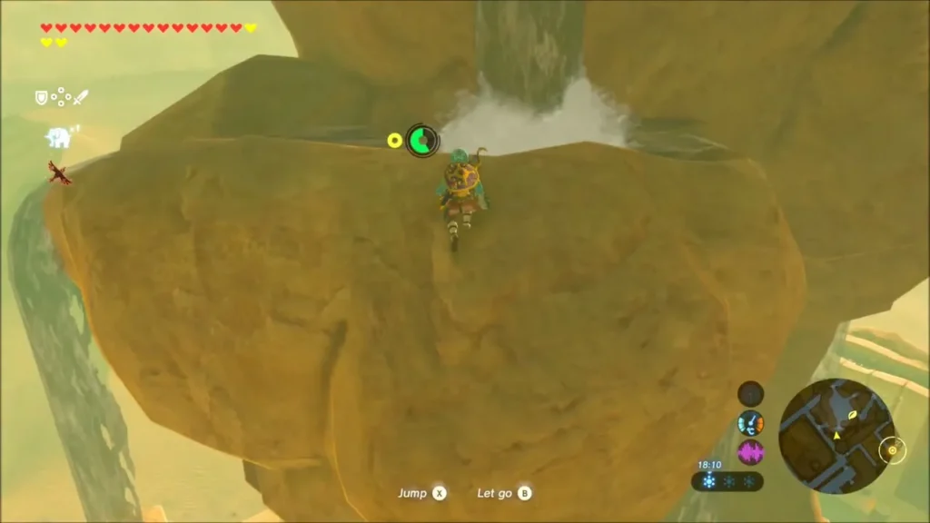 Link hanging from a ledge below the waterfall on the rock tower Link hanging from a ledge below the waterfall on the rock tower