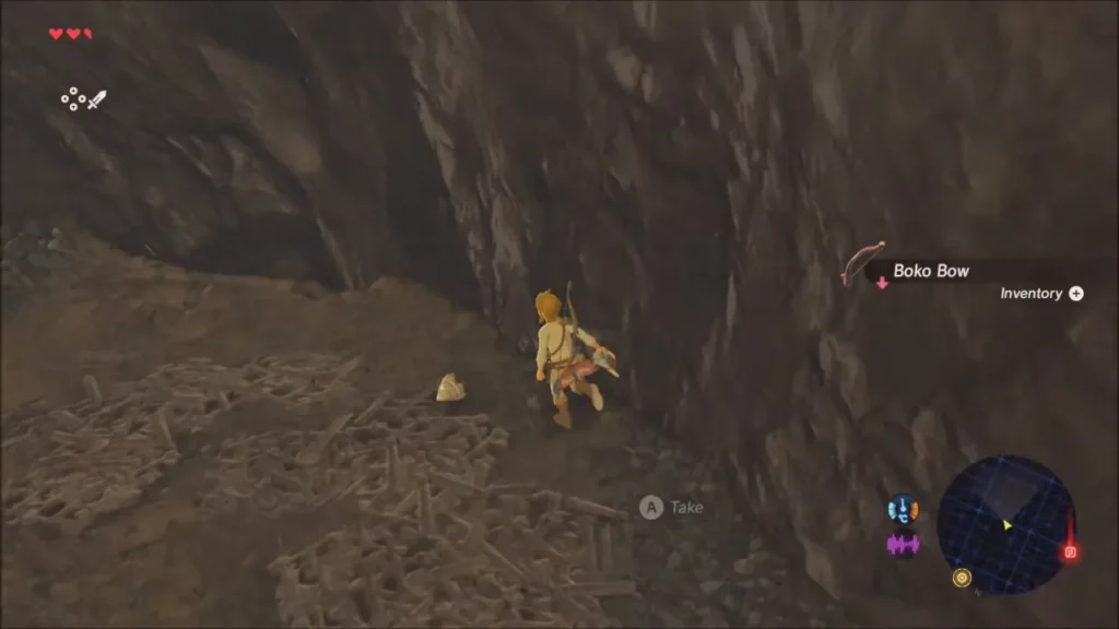 Link in the cave about to take a dropped Boko Bow Link in the cave about to take a dropped Boko Bow