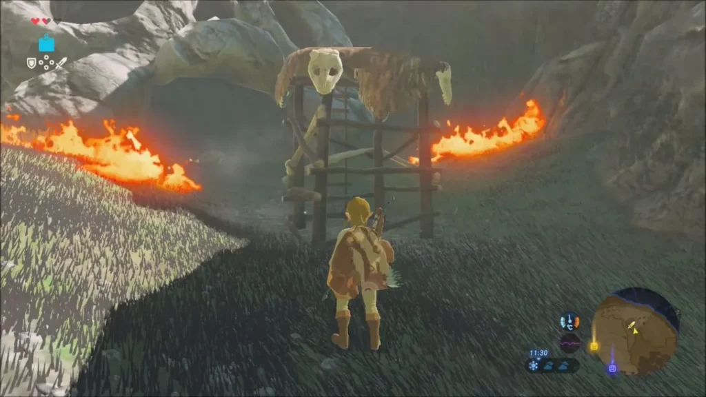 Link facing the skull watchtower with fire burning on both sides Link facing the skull watchtower with fire burning on both sides