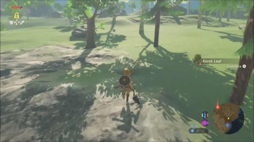 Link running toward a Korok Leaf lying in the grass Link running toward a Korok Leaf lying in the grass