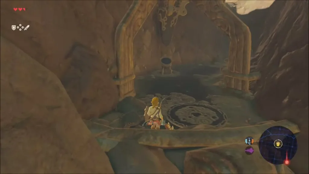 Link standing before the pedestal in a rocky alcove under the boulders Link standing before the pedestal in a rocky alcove under the boulders