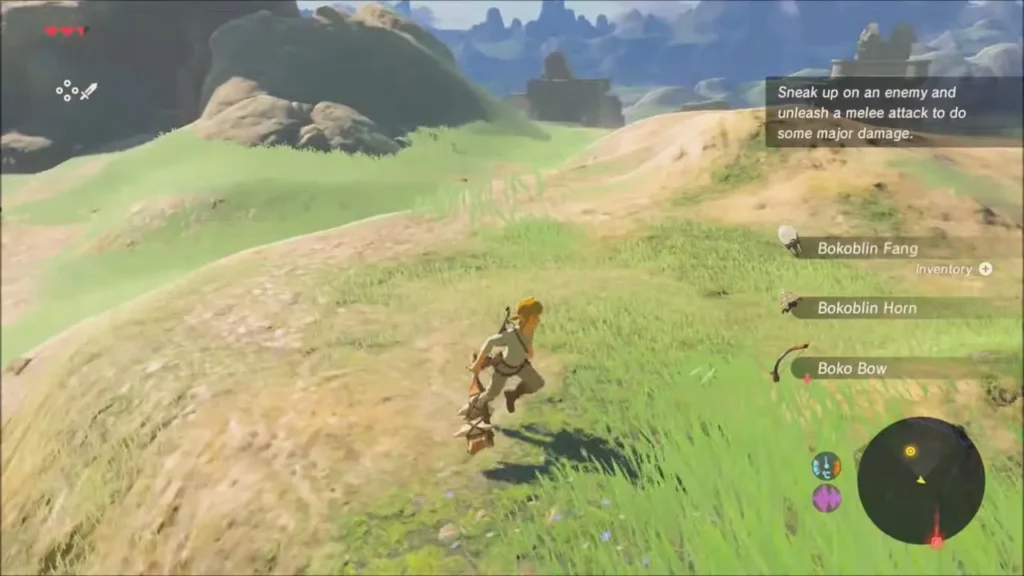 Link crossing a grassy hill while a tip explains sneak attacks Link crossing a grassy hill while a tip explains sneak attacks
