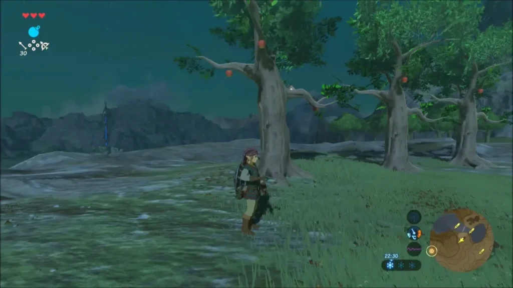 Link standing by a lone tree with red apples hanging in its branches