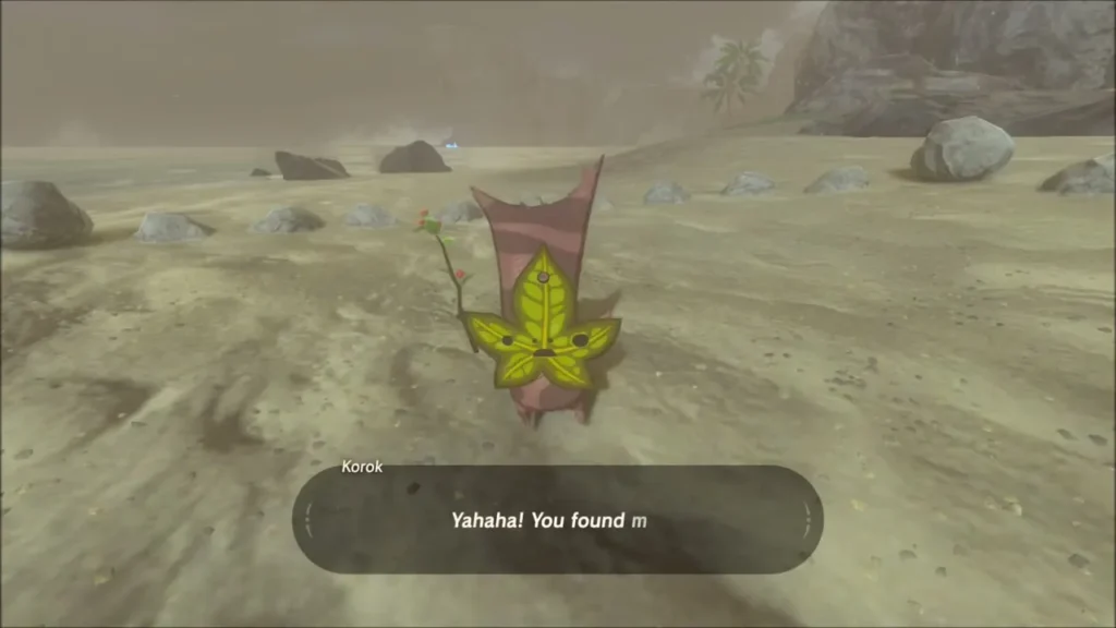 A Korok saying Yahaha on the beach beside the stone ring