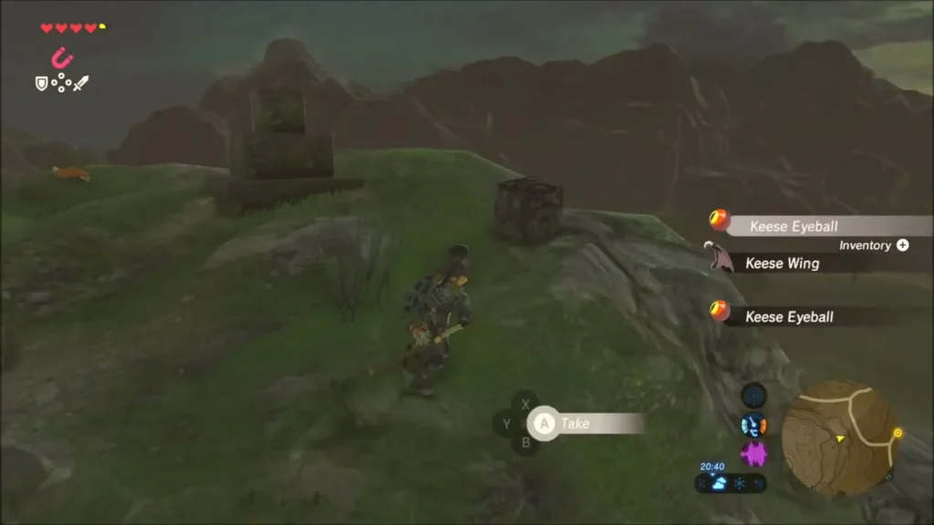 Link on a hilltop beside a small stack of stone blocks