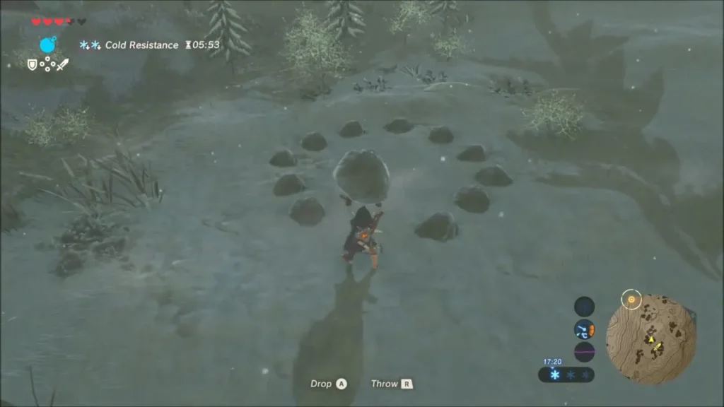 Link holding a boulder beside a ring of small stones with a gap